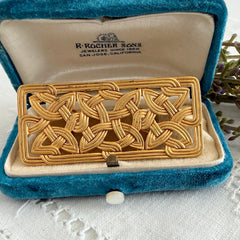 Vintage JJ Jonette brooch with interwoven Celtic knot design in gold‑tone metal, shown from various angles to display details and condition.