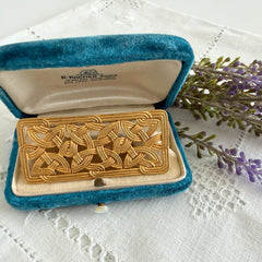 Vintage JJ Jonette brooch with interwoven Celtic knot design in gold‑tone metal, shown from various angles to display details and condition.