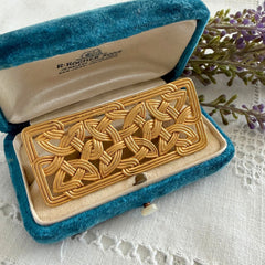 Vintage JJ Jonette brooch with interwoven Celtic knot design in gold‑tone metal, shown from various angles to display details and condition.