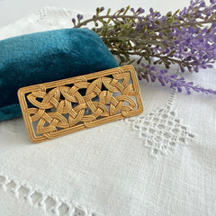 Vintage JJ Jonette brooch with interwoven Celtic knot design in gold‑tone metal, shown from various angles to display details and condition.