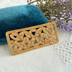 Vintage JJ Jonette brooch with interwoven Celtic knot design in gold‑tone metal, shown from various angles to display details and condition.