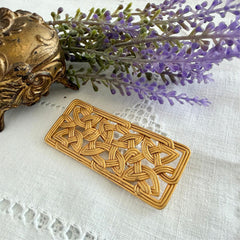Vintage JJ Jonette brooch with interwoven Celtic knot design in gold‑tone metal, shown from various angles to display details and condition.