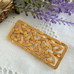 Vintage JJ Jonette brooch with interwoven Celtic knot design in gold‑tone metal, shown from various angles to display details and condition.