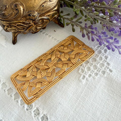 Vintage JJ Jonette brooch with interwoven Celtic knot design in gold‑tone metal, shown from various angles to display details and condition.