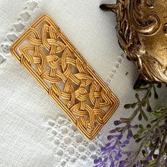 Vintage JJ Jonette brooch with interwoven Celtic knot design in gold‑tone metal, shown from various angles to display details and condition.