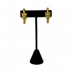 Gold tone vintage nutcracker earrings by JJ, featuring detailed toy soldier figures with tall hats and crossed arms; signed on the back with copyright symbol.