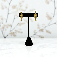Gold tone vintage nutcracker earrings by JJ, featuring detailed toy soldier figures with tall hats and crossed arms; signed on the back with copyright symbol.