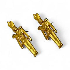 Gold tone vintage nutcracker earrings by JJ, featuring detailed toy soldier figures with tall hats and crossed arms; signed on the back with copyright symbol.