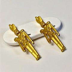 Gold tone vintage nutcracker earrings by JJ, featuring detailed toy soldier figures with tall hats and crossed arms; signed on the back with copyright symbol.