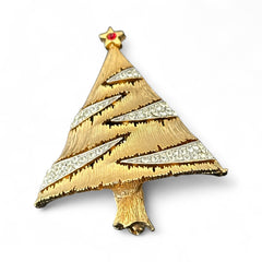 Vintage JJ Christmas tree brooch in textured gold-tone metal with silver-tone garlands paved in clear rhinestones and a red star at the top; signed JJ with copyright mark on the back, typical of 1980s holiday jewelry.