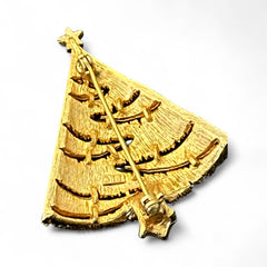 Vintage JJ Christmas tree brooch in textured gold-tone metal with silver-tone garlands paved in clear rhinestones and a red star at the top; signed JJ with copyright mark on the back, typical of 1980s holiday jewelry.