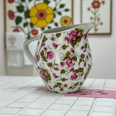 Vintage 1950s Japan porcelain creamer with pink chintz floral pattern, green leaves, and gold trim on rim and handle, marked Made in Japan