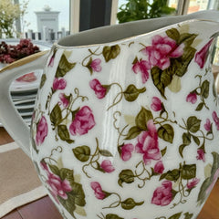 Vintage 1950s Japan porcelain creamer with pink chintz floral pattern, green leaves, and gold trim on rim and handle, marked Made in Japan