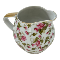 Vintage 1950s Japan porcelain creamer with pink chintz floral pattern, green leaves, and gold trim on rim and handle, marked Made in Japan
