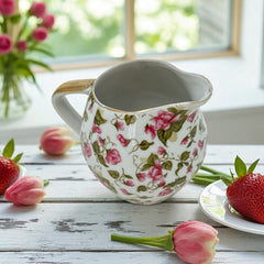 Vintage 1950s Japan porcelain creamer with pink chintz floral pattern, green leaves, and gold trim on rim and handle, marked Made in Japan