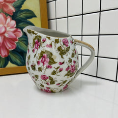 Vintage 1950s Japan porcelain creamer with pink chintz floral pattern, green leaves, and gold trim on rim and handle, marked Made in Japan