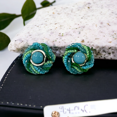 Vintage 1950s Japan clip-on earrings with turquoise bead center, green and turquoise seed beads, and silver tone ring.