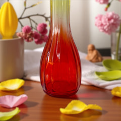 Vintage Jeannette Glass vase with ombre Amberina coloring and fluted design, styled with complementary flowers and soft lighting to highlight its texture, color gradient, and collectible charm.