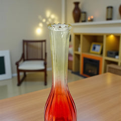 Vintage Jeannette Glass vase with ombre Amberina coloring and fluted design, styled with complementary flowers and soft lighting to highlight its texture, color gradient, and collectible charm.