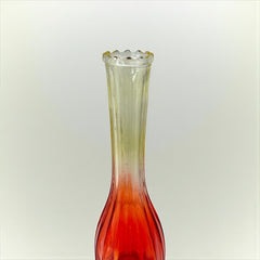Vintage Jeannette Glass vase with ombre Amberina coloring and fluted design, styled with complementary flowers and soft lighting to highlight its texture, color gradient, and collectible charm.