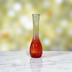 Vintage Jeannette Glass vase with ombre Amberina coloring and fluted design, styled with complementary flowers and soft lighting to highlight its texture, color gradient, and collectible charm.