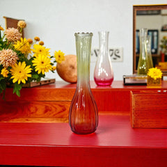Vintage Jeannette Glass vase with ombre Amberina coloring and fluted design, styled with complementary flowers and soft lighting to highlight its texture, color gradient, and collectible charm.