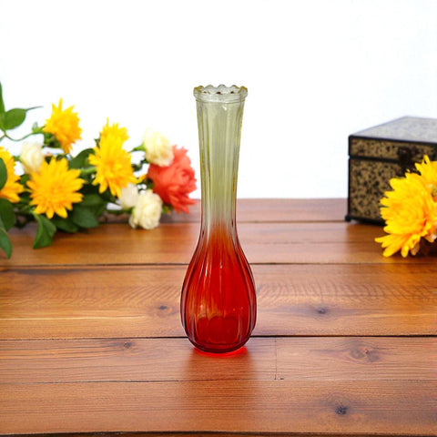 Vintage Jeannette Glass vase with ombre Amberina coloring and fluted design, styled with complementary flowers and soft lighting to highlight its texture, color gradient, and collectible charm.