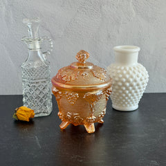 Vintage Jeannette marigold carnival glass candy dish with grape and leaf pattern, iridescent finish, and footed base