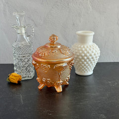 Vintage Jeannette marigold carnival glass candy dish with grape and leaf pattern, iridescent finish, and footed base