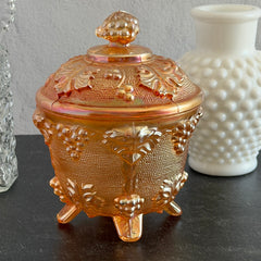 Vintage Jeannette marigold carnival glass candy dish with grape and leaf pattern, iridescent finish, and footed base