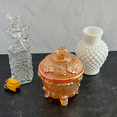 Vintage Jeannette marigold carnival glass candy dish with grape and leaf pattern, iridescent finish, and footed base