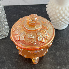 Vintage Jeannette marigold carnival glass candy dish with grape and leaf pattern, iridescent finish, and footed base