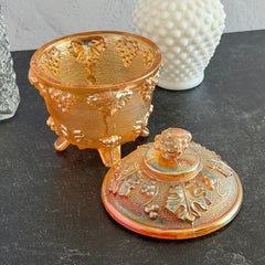 Vintage Jeannette marigold carnival glass candy dish with grape and leaf pattern, iridescent finish, and footed base