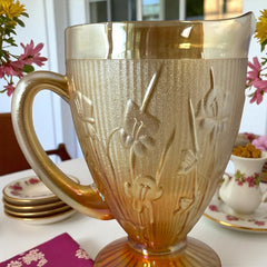 Vintage Jeannette marigold carnival glass pitcher with irises and herringbone pattern, ideal for sustainable home decor or serving drinks in eco-conscious style.