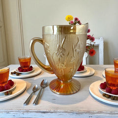 Vintage Jeannette marigold carnival glass pitcher with irises and herringbone pattern, ideal for sustainable home decor or serving drinks in eco-conscious style.