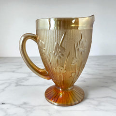 Vintage Jeannette marigold carnival glass pitcher with irises and herringbone pattern, ideal for sustainable home decor or serving drinks in eco-conscious style.