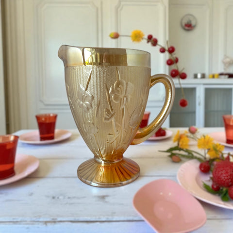 Vintage Jeannette marigold carnival glass pitcher with irises and herringbone pattern, ideal for sustainable home decor or serving drinks in eco-conscious style.