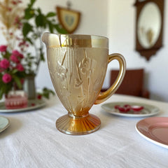 Vintage Jeannette marigold carnival glass pitcher with irises and herringbone pattern, ideal for sustainable home decor or serving drinks in eco-conscious style.