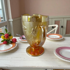 Vintage Jeannette marigold carnival glass pitcher with irises and herringbone pattern, ideal for sustainable home decor or serving drinks in eco-conscious style.