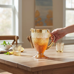 Vintage Jeannette marigold carnival glass pitcher with irises and herringbone pattern, ideal for sustainable home decor or serving drinks in eco-conscious style.