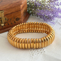 Vintage Joan Rivers gold‑tone link bracelet with rounded segments and elastic stretch design, shown from various angles to display details and condition.