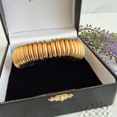 Vintage Joan Rivers gold‑tone link bracelet with rounded segments and elastic stretch design, shown from various angles to display details and condition.