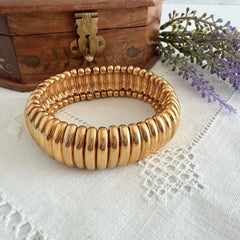 Vintage Joan Rivers gold‑tone link bracelet with rounded segments and elastic stretch design, shown from various angles to display details and condition.