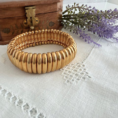 Vintage Joan Rivers gold‑tone link bracelet with rounded segments and elastic stretch design, shown from various angles to display details and condition.