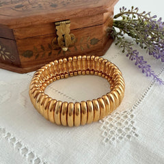 Vintage Joan Rivers gold‑tone link bracelet with rounded segments and elastic stretch design, shown from various angles to display details and condition.