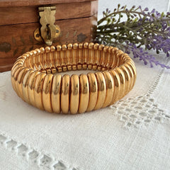 Vintage Joan Rivers gold‑tone link bracelet with rounded segments and elastic stretch design, shown from various angles to display details and condition.