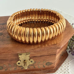 Vintage Joan Rivers gold‑tone link bracelet with rounded segments and elastic stretch design, shown from various angles to display details and condition.