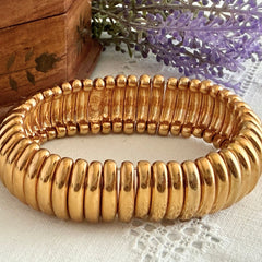 Vintage Joan Rivers gold‑tone link bracelet with rounded segments and elastic stretch design, shown from various angles to display details and condition.