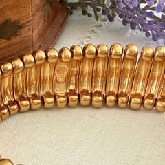 Vintage Joan Rivers gold‑tone link bracelet with rounded segments and elastic stretch design, shown from various angles to display details and condition.