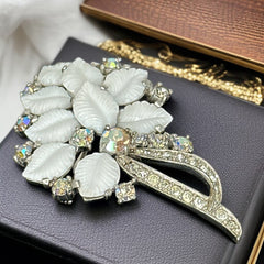 Vintage Jomaz floral spray brooch with molded milk glass leaves and aurora borealis rhinestones in silver tone setting, signed on reverse—1950s mid-century costume jewelry in excellent condition.